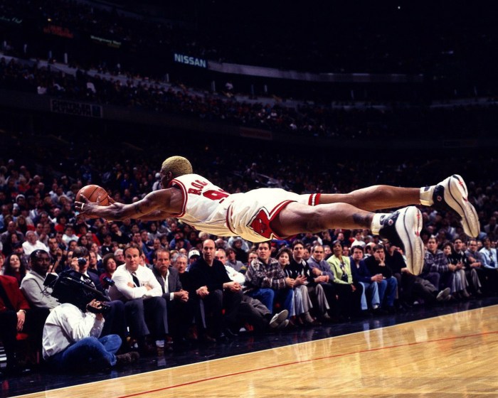 A basketball player grabbing a rebound jumps